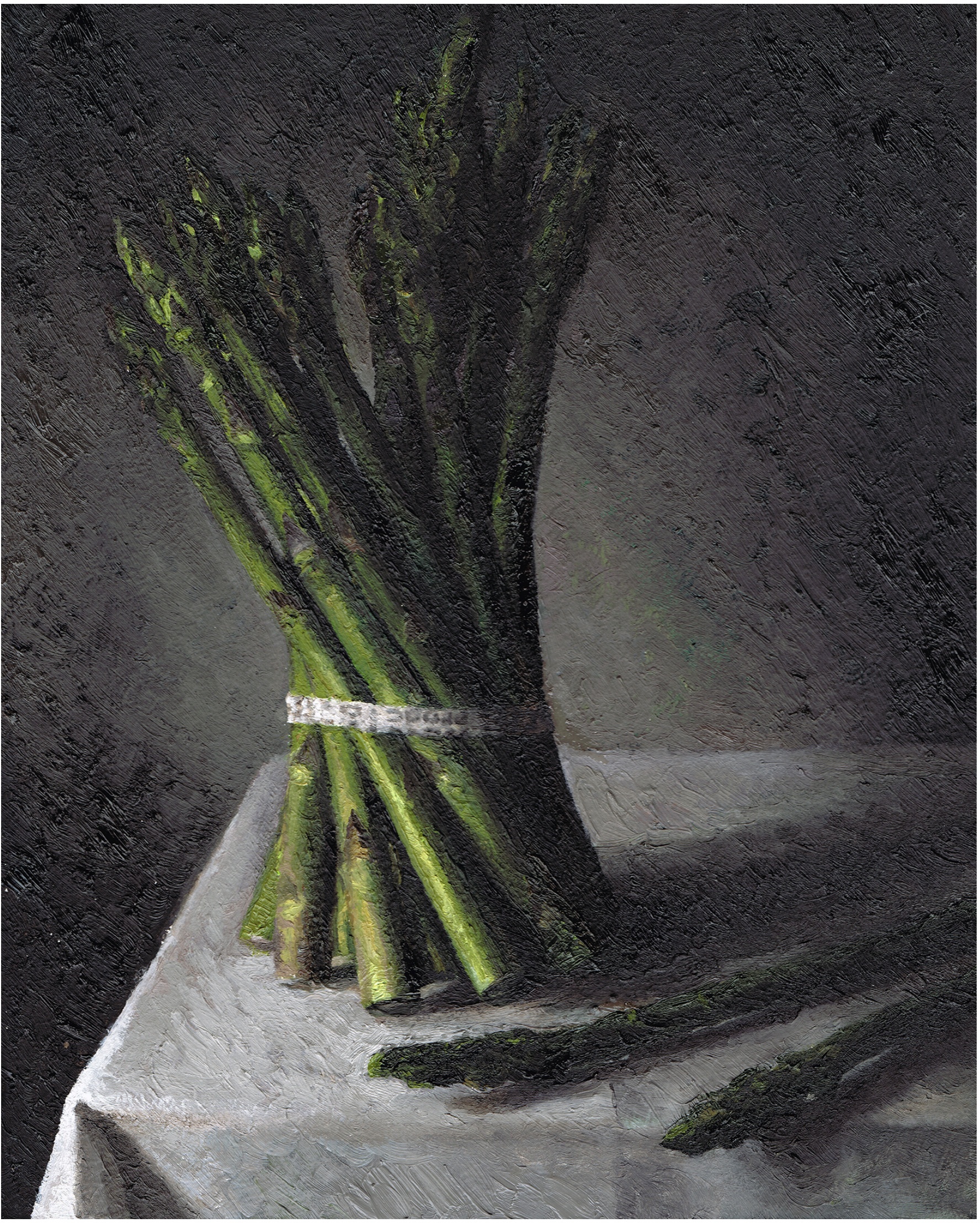 Still life of asparagus on a cloth-covered table